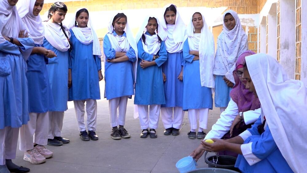 Students at a government girls’ school in Sindh, Pakistan attentively observe a practical session on menstrual hygiene management.
