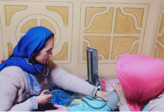 Fida Bibi, midwife from Yasin Valley, in Gligit Baltistan attending to a pregnant woman. 