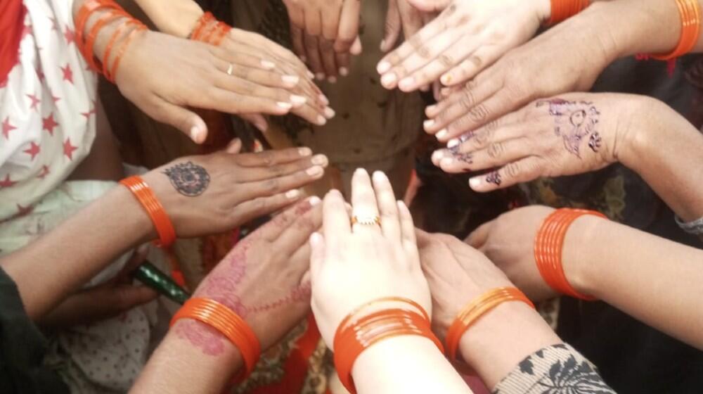 women come together to rally against gender-based violence